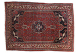 Vintage Bijar rug, cherry red field, navy trefoil medallion, rams horn finials, geometric Herati.