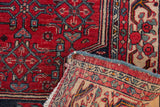 Vintage Bijar rug corner, revealing hand-knotted foundation, red Herati motif, and secure blue selvage.
