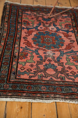 Vintage Mehrivan rug detail: blush, blue, red floral border, and lightly tattered fringe.