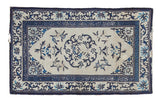 Antique Peking rug with ivory field, roundel medallion, blue floral elements, and Greek key border.