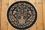 Round Art Deco Chinese rug featuring charcoal, sand, sky blue, and blush tree-of-life motif. 2x2.
