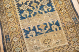 Antique Caucasian geometric flower main border and abrashes field in blues and gold.