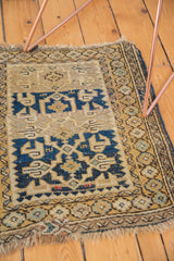 Detail of hand-knotted geometric flower border and fringe on an antique Caucasian mat.