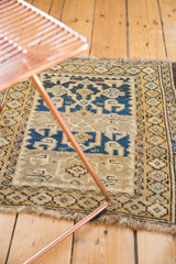 Hand-knotted antique Caucasian rug featuring geometric motifs and time-softened blue and gold abrash.