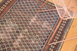 Antique Caucasian Shirvan rug with navy lattice field and intricate floral border details.