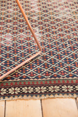 Antique Shirvan rug: unusual pawn motif border and finely woven lattice field in navy, red, ivory.