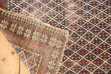 Antique Shirvan rug corner revealing hand-knotted lattice field, patterned reverse, and aged fringe.