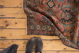 Vintage Heriz runner showing oversized palmettes in maroon, powder blue, and bronze brown.