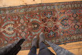 Vintage Heriz runner's oversized palmettes and rare maroon, sky blue coloration.