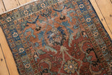 Vintage Heriz runner's oversized palmette design and geometric border in maroon, sky blue, and bronze.