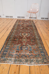 Heriz runner end: fringed border, large palmettes in maroon, blues, and ivory.