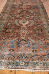 Hand-knotted vintage Persian Heriz runner with large palmettes in maroon, blue, ivory, and fringe.
