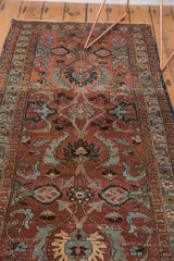 Intricate vintage Heriz runner pattern with large palmettes in rich maroon, powder blue, and bronze.