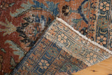 Vintage Heriz rug corner showing faded palmette pile and intricate hand knotted foundation.