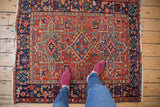 Hooked main medallion of a vintage Karaja rug, rich geometric field, cherry red and navy.