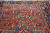 Hand-knotted Karaja rug: red field with geometric patterns, sky blue, and navy border.