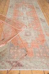 Vintage Distressed Oushak runner with terracotta, beige, and aubergine geometric motifs and even wear.