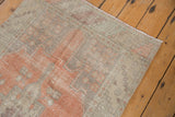 Distressed Oushak runner's terracotta, beige geometric pattern with even wear.