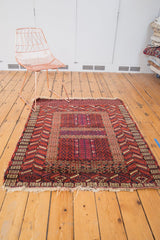 Turkmen rug corner, germinating plants, rams horn motifs, dark cherry red, navy, ivory.
