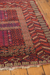 Vintage Turkmen rug panel with germinating plant motifs and serrated borders in cherry red, navy.