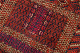 Dark cherry red and navy serrated leaf and hand-like motifs on a vintage Turkmen rug.
