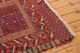 Geometric motifs transition to patterned end band and ivory fringe.