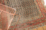 Antique Persian Hamadan rug detail: allover field of staggered navy botehs and brick red paisley border.