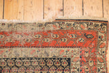 Hand-knotted antique Hamadan rug corner, brick red boteh field, detailed navy and ivory border.