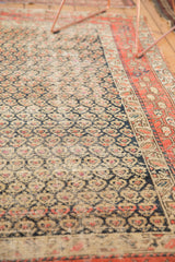 Staggered navy and brick red boteh patterns on antique Hamadan field, plus its detailed border.