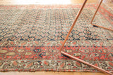 Antique Hamadan rug's field with navy boteh motifs and red stylized border.