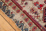 Antique Seichor rug edge showing blue and red reciprocating wave motif outer border.