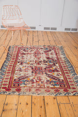Reciprocating wave border and fringe on antique Caucasian Seichor rug, time-softened ivory ground.
