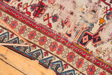 Antique Caucasian Seichor rug showing blue reciprocating wave and blush floral borders.