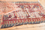 Reciprocating wave motif border on the antique Seichor rug with exposed foundation.