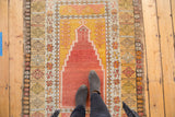 Vintage Turkish Melas prayer rug, central mehrab, germinating plant motif, softened palette.