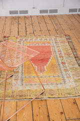 Vintage Turkish Melas prayer rug with softened terracotta, saffron, and geometric patterns.