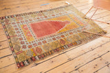 Vintage Turkish Melas rug corner with terracotta, saffron geometric borders and visible softened wear.