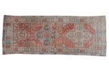 Distressed vintage Oushak runner featuring geometric double medallions in terra cotta, blue, ivory. 3'9