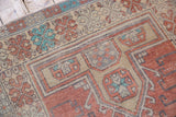 Distressed vintage Oushak runner with hook-and-latch motifs, dusty terra cotta, and aqua blue.