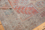 Decorative distressed Oushak rug corner with dusty terra cotta, beige, aqua blue motifs and moderate wear.