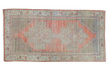 Distressed Oushak runner with faded dusty rose field and double beige medallions.