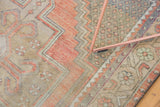 Distressed Oushak runner detail showing zigzag patterns and lattice motifs in rose, beige.