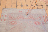 Distressed vintage Oushak rug section, with muted geometric patterns and low pile wear.