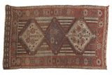 Antique Qashqai rug with triple medallions, channels of water motif, muted reds, blues, ivory.