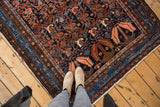 Vintage Hamadan rug's large serrated leaf, detailed vinery in navy, rust, and blush.