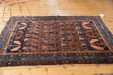 Vintage Hamadan rug featuring blush serrated leaves and intricate vinery on a navy field.