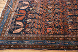 Vintage Hamadan rug corner, showcasing navy field with blush serrated leaves and intricate geometric borders.