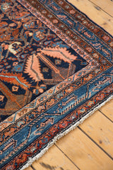 Vintage Hamadan rug corner, with navy, blush, rust borders and large serrated leaf designs.