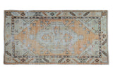Distressed Oushak runner with faded tangerine medallion, pale seafoam field, and serrated leaf border.