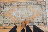 Vintage Distressed Oushak rug runner with faded tangerine orange, seafoam green, and geometric design.